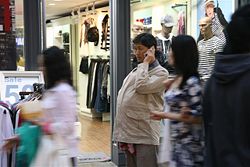 Middle aged Korean man on hand phone.
