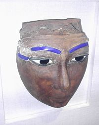 An Egyptian coffin mask made of wood and glass, from the New Kingdom, dated to Dynasty 18 or 19 (1550-1196 B.C.E.). From the Freer and Sackler Galleries of Washington D.C.
