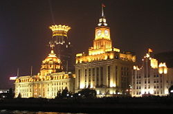 The Bund at night. Cathay Hotel (now Peace Hotel), Customs House and the Hong Kong and Shanghai Bank in the foreground; the Bund Financial Center in the background (Shanghai, China)