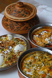 Hyderabadi biryani served with other Indian dishes.