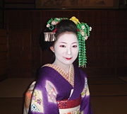 A maiko in the Gion district of Kyoto, Japan, in full makeup. The lipstick style indicates that she is still new.