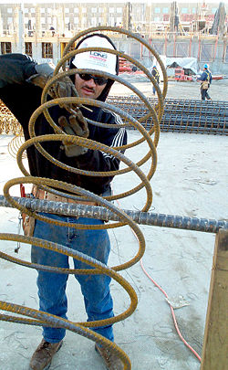 A construction worker works with rebar that will be used in a column