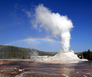 Steam phase eruption of Castle Geyser demonstrates primary and secondary rainbows and Alexander's band at Yellowstone National Park.