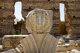 Gorgon head sculpture in Leptis Magna. Image by Luca Galuzzi, 2007.