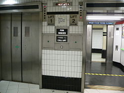 A set of elevators (or lifts) in the lower level of a London Underground station