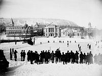 Playing hockey on the skating rink, McGill University, 1884.