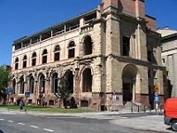 Bank Polski in 2004. During the Warsaw Uprising, much of ulica Długa (Long Street) was reduced to ruins. The Bank Polski (Bank of Poland) redoubt, in the 1944 photo (above), is one of the few buildings on that street still standing. Photo below shows the Bank still bearing the scars of the Uprising. The lighter-colored bricks were added during the building's reconstruction after 2003.