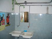 Color-coding hot- and cold-water faucets is common in many cultures but, as this example shows, the coding may be rendered meaningless because of context. The two faucets were probably sold as a coded set, but the code is unusable (and ignored) as there is a single water supply.