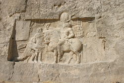 Rock-face relief at Naqsh-e Rustam of Shapur I (on horseback) with Philip the Arab and (perhaps) Emperor Valerian.
