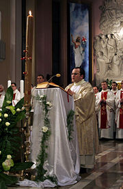 A Roman Catholic deacon proclaims the Gospel in Poland.
