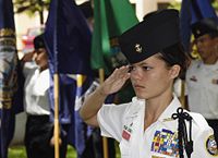A Navy JROTC cadet salutes during the parading of the colors ceremony held at Pearl Harbor, Hawaii.