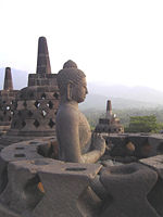 A Buddha statue with the hand position of dharmachakra mudra (turning the Wheels of the Law).