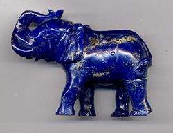 An Elephant carving in high quality lapis lazuli, showing gold-colored inclusions of pyrite. These inclusions are common in lapis and are an important help in identifying the stone. The carving is 8 centimeters (3 inches) long.