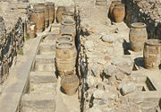 Magazine 4 with giant pithoi. The compartments in the floor were for grain and produce.