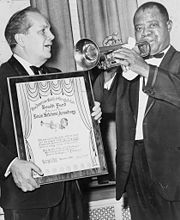 Louis Armstrong receives an award at Carnegie Hall.