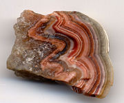 The agate-like sardonyx (banded agate). The specimen is one inch (2.5 centimeters) wide.