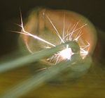 Modern flint spark lighter being struck.