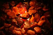 Cloudy unpolished amber, artificially illuminated.
