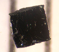 A small sample of the high-temperature superconductor BSCCO-2223 (bismuth strontium calcium copper oxide); the two lines in the background are 1 mm apart