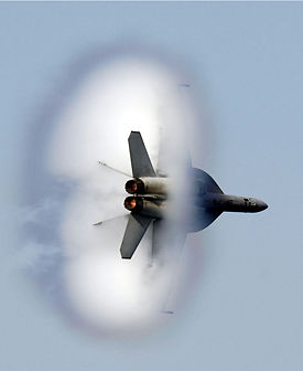 A United States Navy F/A-18E/F Super Hornet in transonic flight.