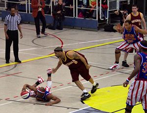 A Globetrotter puts on a dribbling exhibition against a member of the New York Nationals.