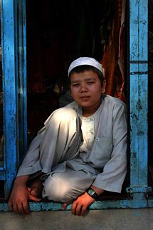 A young Hazara boy poses for a photograph outside his home near Mazari Sharif, northern Afghanistan.