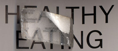 The letters on a paper covered by a calcite crystal show up as doubled. This is an example of the phenomenon of birefringence (double refraction).