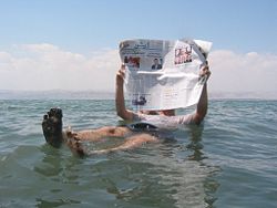 A tourist demonstrates the unusual buoyancy caused by high salinity.