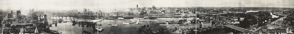 Mississippi riverfront and Saint Anthony Falls in 1915. At left, Pillsbury, power plants, and the Stone Arch Bridge. The tall building is Minneapolis City Hall. In the foreground to the right are Nicollet Island and the Hennepin Avenue Bridge.