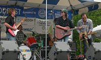The Christy McWilson Band perform at the Ballard Seafood Fest, Ballard, Seattle, Washington. Blackie Rad at left; Christy McWilson, of course, at center; other musicians unidentified.