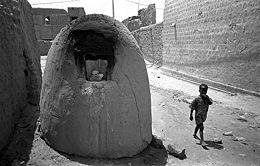 A typical street scene in Timbuktu, with omnipresent bread-baking ovens.
