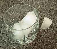 These ice cubes, having been placed in a glass above their melting point, are beginning to melt