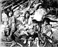 Two Tlingit women with several children near the Kotsina River, Alaska. Miles Brothers photograph, 1902.