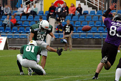 A player attempts a field goal.