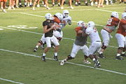 A quarterback searching for an opportunity to throw a pass