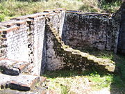Remains of the solitary cells on Sarah Island's penal colony, part of the Macquarie Harbour Historic Site. The cells are barely large enough to lie down in, and were completely dark inside.