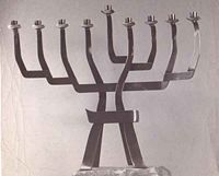 A nine branched Chanukkiyah lit during Hanukkah