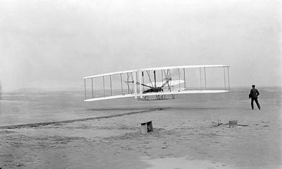 First flight, December 17, 1903. Photo taken by John T. Daniels, of the Kitty Hawk Life Saving Station, using Orville's tripod camera.