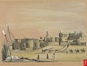 Part of the town of Karachi, with mud houses; camels and villagers in foreground. April 1851