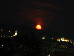 When the moon is close to the horizon, it appears to be much larger.