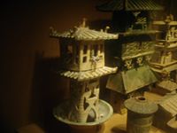 Eastern Han tomb models of watchtowers; the one on the left has crossbowmen in the top balcony. Zhang wrote that Western Han emperors were entertained by displays of archery from the balconies of towers along Chang'an's Kunming Lake.