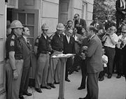 Wallace standing against desegregation while being confronted by Deputy U.S. Attorney General Nicholas Katzenbach at the University of Alabama in 1963.
