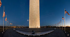 An ultra wide angle view of the monument showing the American flags arranged around it