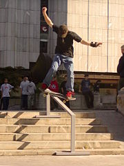 A skateboarder performing a frontside lipslide