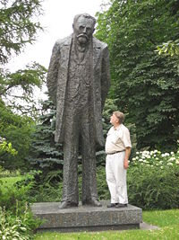 Statue of Bolesław Prus on Warsaw's Krakowskie Przedmieście, in a garden adjacent to Hotel Bristol. (The man is 5 feet, 11 inches tall.)