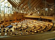 The debating chamber of the Scottish Parliament contains a shallow horseshoe of seating for the Members of the Scottish Parliament.