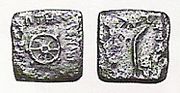 Indian-standard coinage of Menander I with a Buddhist eight-spoked wheel, and a palm of victory on the reverse (British Museum).