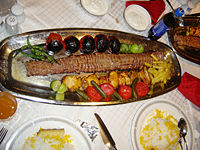 The ubiquitous Persian Kebab is often served with both plain rice and a special (yellow cake) rice called tah-chin.