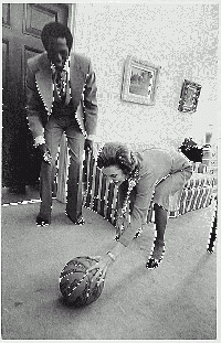 Globetrotters player Meadowlark Lemon presenting a ball signed by the team to First Lady Betty Ford in 1974.