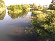 The outlet of a wastewater treating plant flows into a small river.